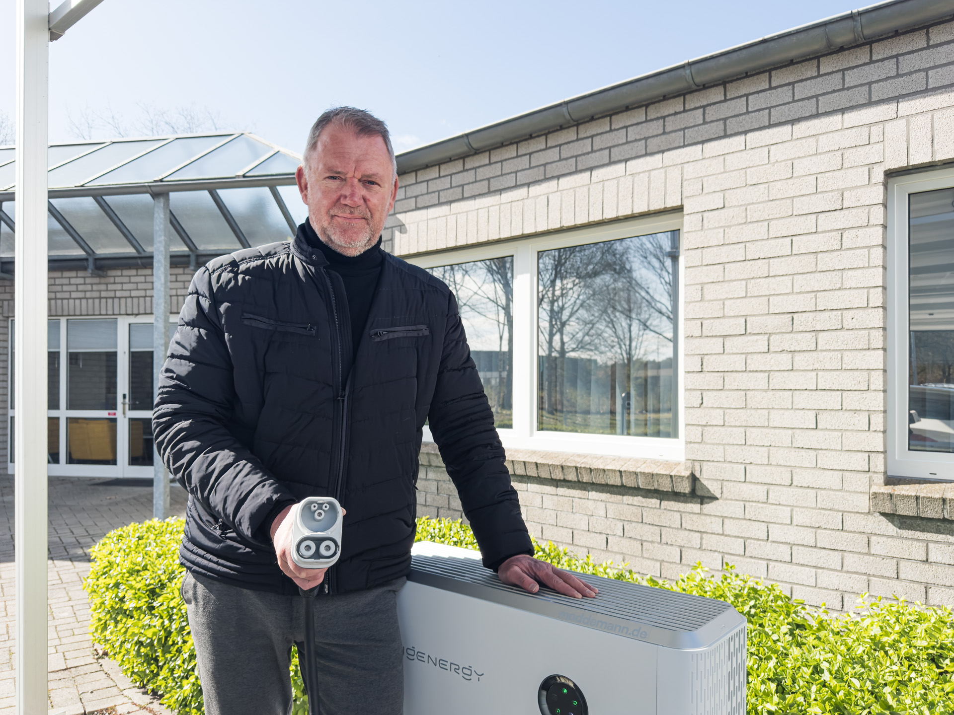 Der Geschäfstführer Ewald Moddemann steht vor der bidirektionalen Ladestation von Sigenergy.
